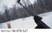The shooter in camouflage targets a target with a rifle with an optical sight, focus on weapons. Стоковое фото, фотограф David Kashakhi / Фотобанк Лори