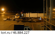 Close view of aircraft fuselage near the entering baggage door, at night. Редакционное фото, фотограф David Kashakhi / Фотобанк Лори