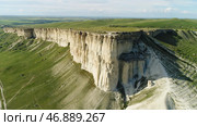 Aerial for unusual shaped mountain and green field with trees. Стоковое фото, фотограф David Kashakhi / Фотобанк Лори