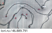 Aerial view of the karting track with moving small red karts, race and motorsport concept. Стоковое фото, фотограф David Kashakhi / Фотобанк Лори