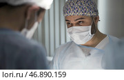 Men in clean uniform doing the procedure at the emergency surgery center. Стоковое фото, фотограф David Kashakhi / Фотобанк Лори