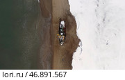 Flying above the winter snowy coast by the sea and the old rusty ship. Стоковое фото, фотограф David Kashakhi / Фотобанк Лори