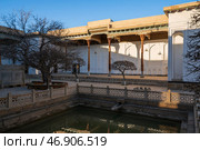 View of the courtyard of the Bahauddin Naqshbandi Memorial Complex with a pond in the foreground on a sunny day, Bukhara, Uzbekistan. Стоковое фото, фотограф Ula Ulachka / Фотобанк Лори