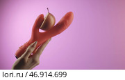 Pink background.Creative.Vibrator, held in hand, into which they put a bright red apple and poured with a slimy white cream. Стоковая иллюстрация, иллюстратор David Kashakhi / Фотобанк Лори