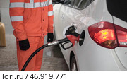 Gas Station Worker Refilling Car at Service Station. Редакционное фото, фотограф David Kashakhi / Фотобанк Лори