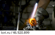 Blacksmith aligns leaves of iron rose and makes the final shape of the flower. Стоковое фото, фотограф David Kashakhi / Фотобанк Лори
