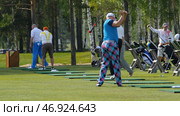 Golfers hit sweeping golf course in the summer. Стоковое фото, фотограф David Kashakhi / Фотобанк Лори