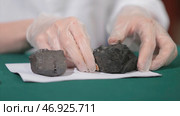 Male hands in gloves holding coal. Стоковое фото, фотограф David Kashakhi / Фотобанк Лори