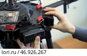 Close up for hands putting battery into the quadcopter, filming preparation. Стоковое фото, фотограф David Kashakhi / Фотобанк Лори