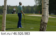 Golfers hit sweeping golf course in the summer. Стоковое фото, фотограф David Kashakhi / Фотобанк Лори