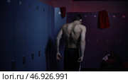 Boxer after defeat of evil frustration and threw towel on floor of dark locker room. Стоковое фото, фотограф David Kashakhi / Фотобанк Лори