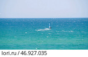 Windsurfer in the sea, man on windsurf conquering the waves, enjoying extreme sport, active lifestyle, happy summer vacation. Стоковое фото, фотограф David Kashakhi / Фотобанк Лори