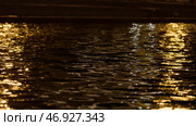 Close up of moving water surface with the reflection of lantern lights. Стоковое фото, фотограф David Kashakhi / Фотобанк Лори