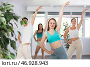 Cheerful teen girl enjoying while training movements of modern group dance in choreography class. Стоковое фото, фотограф Яков Филимонов / Фотобанк Лори