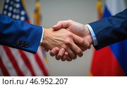 Handshake cooperation between United States and Russia in negotiations agreement business diplomacy collaboration international partnership, success, flags, unity consensus. Стоковое AI-изображение, AI-художник Павел Муравьев / Фотобанк Лори