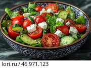 A plate with a bright and appetizing Greek salad. The dish includes fresh vegetables: red ripe cherry tomatoes, sliced ​​cucumbers, green lettuce leaves. The salad also contains cubes of snow-white feta cheese, fresh basil leaves and coarsely ground black pepper, which adds piquancy to the dish. All this is served in a beautiful painted plate on a dark background, which emphasizes the brightness of the ingredients. Стоковое AI-изображение, AI-художник Анна Кривицкая / Фотобанк Лори