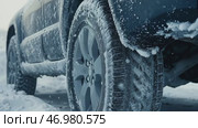 Icy car. Ice-covered vehicle. Frozen Auto Covering by Snow. Vehicle during Snowstorm. Hazardous Winter Road Driving. Cold Season. Corrosion, Rust. Close-up of tires. Trail of tread marks in thick snow. Стоковое AI-видео, аниматор Марина Демидюк / Фотобанк Лори