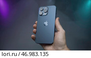 Promotional video of new iPhone model 15 pro max on isolated background with fog (2023 год). Редакционное фото, фотограф David Kashakhi / Фотобанк Лори