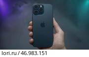 Promotional video of new iPhone model 15 pro max on isolated background with fog (2023 год). Редакционное фото, фотограф David Kashakhi / Фотобанк Лори