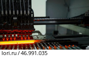 Factory machine at work: printed circuit board being assembled with automated mechanism. Стоковое фото, фотограф David Kashakhi / Фотобанк Лори