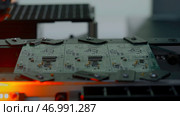 Close up of industrial background with printed circuit board being assembled with automated robotic arm. Стоковое фото, фотограф David Kashakhi / Фотобанк Лори