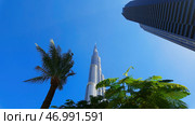 Ground angle of blue sky with tall buildings around. Стоковое фото, фотограф David Kashakhi / Фотобанк Лори