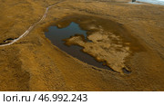 Idyllic countryside landscape with tiny lake in dried yellow field. Стоковое фото, фотограф David Kashakhi / Фотобанк Лори