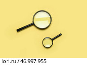 Черные увеличители на желтом фоне. Стоковое фото, фотограф Pixel_shot / Фотобанк Лори
