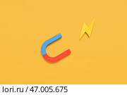 Лошадиная подкова в форме магнита с бумажной молнией на желтом фоне. Стоковое фото, фотограф Pixel_shot / Фотобанк Лори