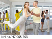 Cheerful young adult couple dancing lindy hop at dance rehearsal. Стоковое фото, фотограф Яков Филимонов / Фотобанк Лори