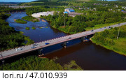 Arial view of a small town crossed by a river with a bridge. Стоковое фото, фотограф David Kashakhi / Фотобанк Лори