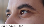 Close-up of brown eyes of man looking into distance. Стоковое фото, фотограф David Kashakhi / Фотобанк Лори