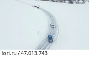 Aerial view of drifting cars on the snow covered off road. Стоковое фото, фотограф David Kashakhi / Фотобанк Лори