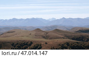 Picturesque valley with yellow meadows and giant cold mountains with white peaks. Стоковое фото, фотограф David Kashakhi / Фотобанк Лори