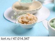 Чашка с мочалкой и цветами на голубом фоне, крупным планом. Концепция массажа тела. Стоковое фото, фотограф Pixel_shot / Фотобанк Лори