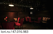 Beautiful space in nightclub with tables and garlands. Стоковое фото, фотограф David Kashakhi / Фотобанк Лори