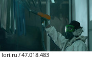 Process of powder coating of metal parts at a steel factory. Стоковое фото, фотограф David Kashakhi / Фотобанк Лори