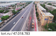 A drone over a section of the city's asphalt road during repairs. Sunny summer day. Стоковое видео, видеограф Aleksey Kidisyuk / Фотобанк Лори