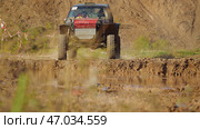 An SUV prepared for heavy off-roading goes to a muddy puddle. Extreme racing on off-roaders. Стоковое фото, фотограф Воловодов Владимир / Фотобанк Лори