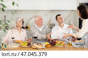 Birthday senior man accepts outright gift and greetings from adult daughter during family feast. Стоковое фото, фотограф Яков Филимонов / Фотобанк Лори
