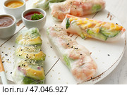 Вкусные блинчики с начинкой с соусами на белой доске, крупным планом. Стоковое фото, фотограф Pixel_shot / Фотобанк Лори