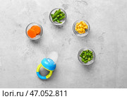 Чаши с разной едой и детским клевом на столе. Стоковое фото, фотограф Pixel_shot / Фотобанк Лори