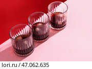Стаканы рома с кубиками льда на розовом фоне. Стоковое фото, фотограф Pixel_shot / Фотобанк Лори