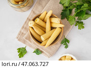 Чаша с вкусными консервированными початками кукурузы на светлом фоне. Стоковое фото, фотограф Pixel_shot / Фотобанк Лори