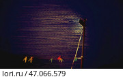 Lantern illuminates rapidly falling snow in slow motion. Стоковое фото, фотограф David Kashakhi / Фотобанк Лори