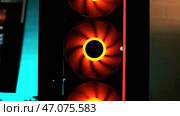 Close up of modern system unit of a computer with cooling fan and led lights. Стоковое фото, фотограф David Kashakhi / Фотобанк Лори