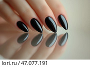 Elegant black manicured hand showcasing glossy pointed nails. Элегантная рука с черным маникюром и блестящими заостренными ногтями. Стоковое AI-изображение, AI-художник Katsiaryna Repich / Фотобанк Лори