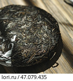 A beautiful Artisan Loose Tea Cake on a rustic Wooden Table, inviting tea lovers to indulge. Стоковое фото, фотограф David Kashakhi / Фотобанк Лори