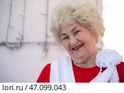 April 28, 2022. Belarus, the city of Gomil. Holiday on the street of the city. Portrait of a funny elderly woman, she is smiling at the camera. A ninety year old woman. Редакционное фото, фотограф Лазаренко Светлана / Фотобанк Лори