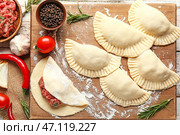 Доска с блинчиками из сырого мяса и ингредиентами на светлом деревянном фоне, крупным планом. Стоковое фото, фотограф Pixel_shot / Фотобанк Лори